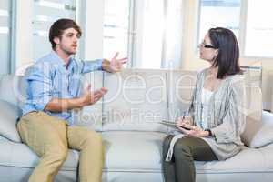 Psychologist talking with depressed man