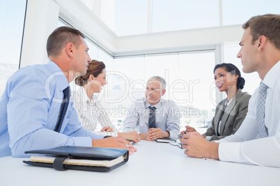 Business team sitting together around the table