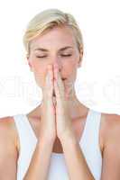 Attractive blonde woman praying