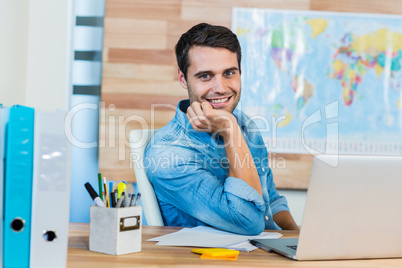 Handsome travel agent smiling at camera