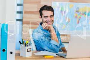 Handsome travel agent smiling at camera