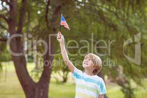 Young boy holding an american flag