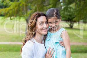 Happy mother and daughter smiling at the camera