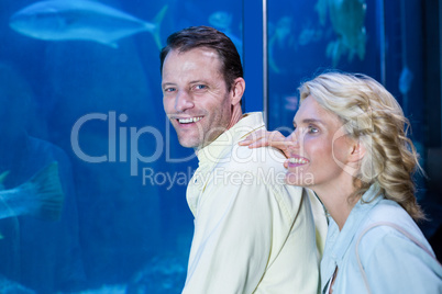 Happy couple looking at fish tank