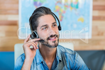 Smiling travel agent having phone call