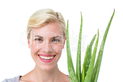 Attractive woman holding aloe vera plant