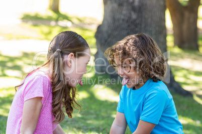 Little siblings making funny faces at camera