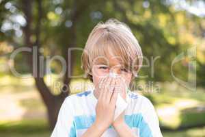 Little boy blowing his nose