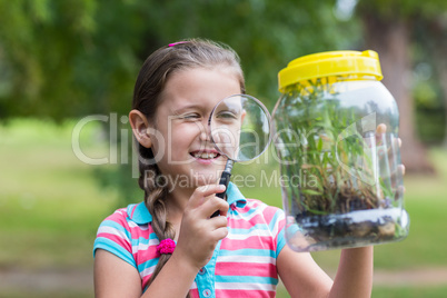 Curious little girl looking at jar