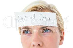 Anxious blonde woman with sign on her forehead