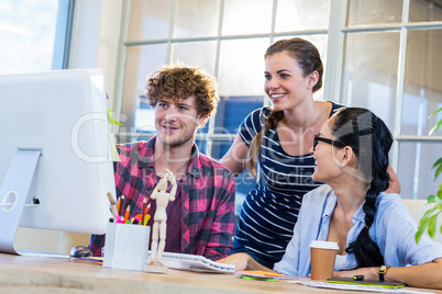 Smiling partners working together on computer