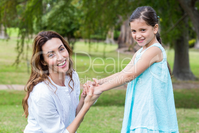 Happy mother and daughter smiling at the camera Happy mother and daughter smiling at the camera