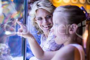 Happy family looking at starfish in a tank