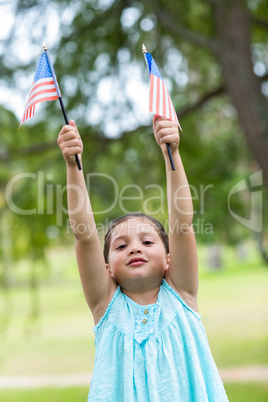 Little girl waving american flag