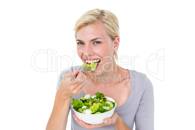 Happy blonde woman holding bowl of salad