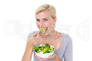 Happy blonde woman holding bowl of salad