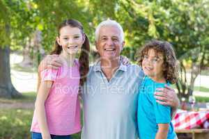 Extended family smiling in the park