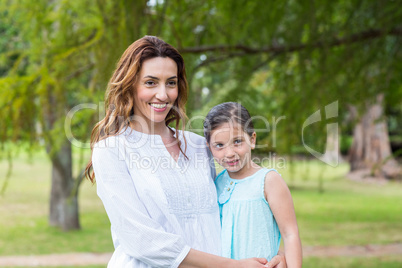 mother and daughter smiling at the camera