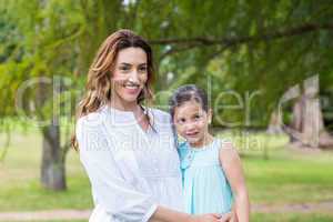 mother and daughter smiling at the camera