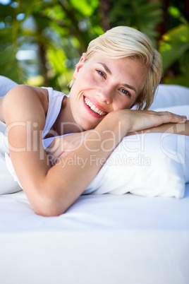 Beautiful blonde woman lying outside