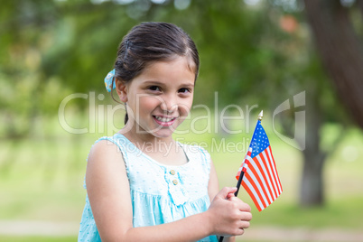 Little girl waving american flag