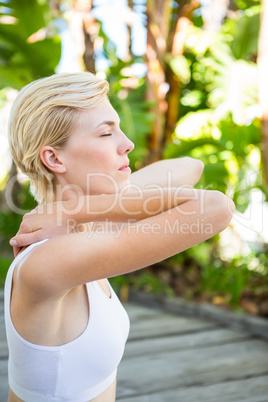 Fit blonde woman meditating