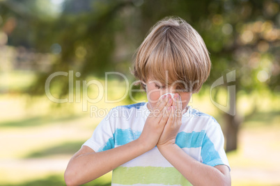 Little boy blowing his nose