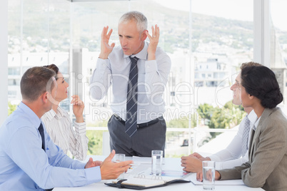 Irritated businessman talking to his team