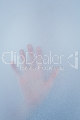 Hand touching frosted glass