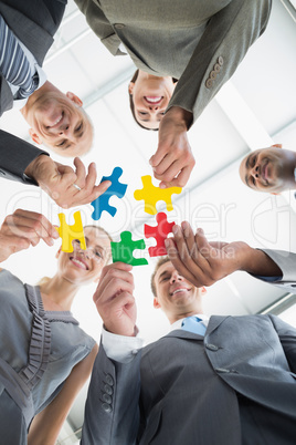 Business colleagues holding piece of puzzle