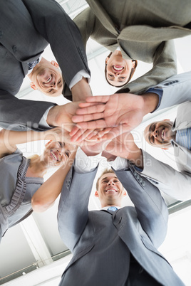 Employees putting hands together