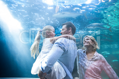 Happy family enjoying behing a fish tank