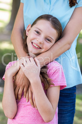 Happy mother and daughter smiling at the camera