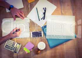 Designer working at desk overhead shot