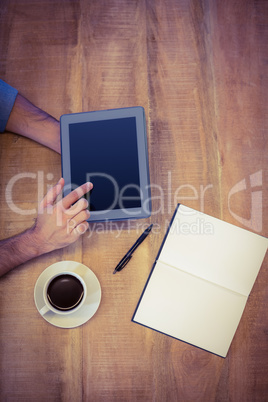 Man using tablet having coffee
