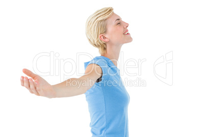 Blonde woman standing arms outstretched