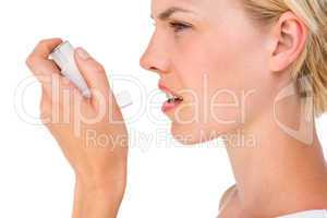 Asthmatic pretty blonde woman using inhaler