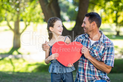 Father and daughter smiling in the park