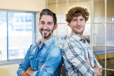 Smiling team standing arms crossed