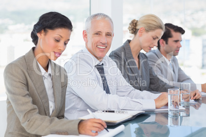 Business team taking notes during conference