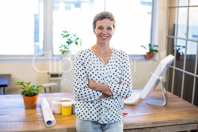 Smiling woman standing arms crossed