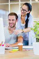 Smiling partners working together on computer