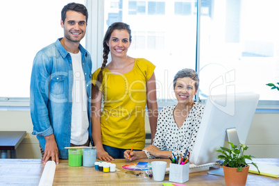 Casual business team smiling at camera during meeting