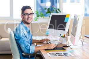 Casual businessman using digitizer at his desk