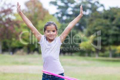 happy girl playing with hula hoops