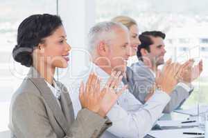 Business team applauding during conference