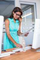 Smiling casual businesswoman working with photos