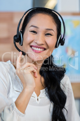 Pretty travel agent smiling at camera