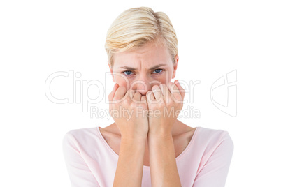 Anxious blonde woman looking at camera