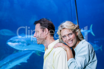 Happy couple looking at fish tank